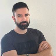 A person with a beard and mustache

AI-generated content may be incorrect.